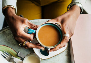 person Holding Coffee Cup Top View 1213479257 770x533 1