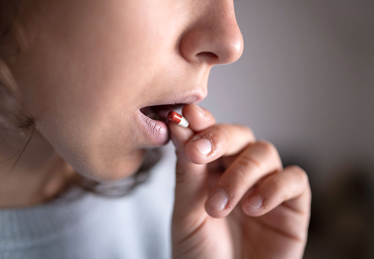 person Putting Capsule In Mouth 1277453146 770x533 1