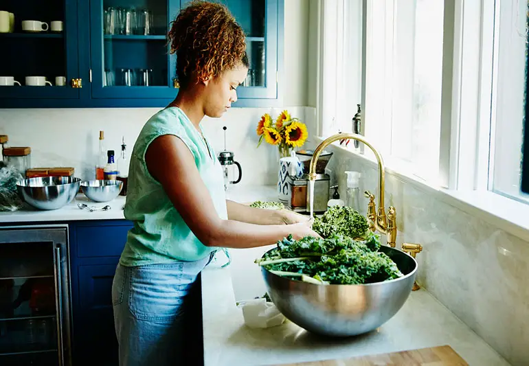 person Washing Veggies at sink 675994329 770x533 1